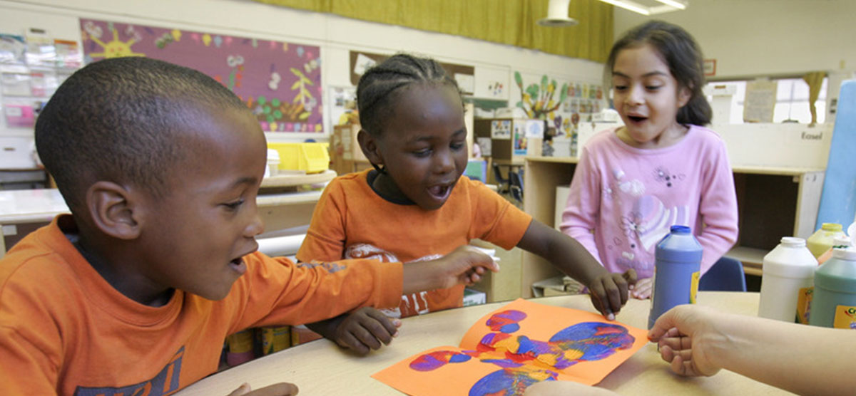 Children joyful and creating art together in a classroom