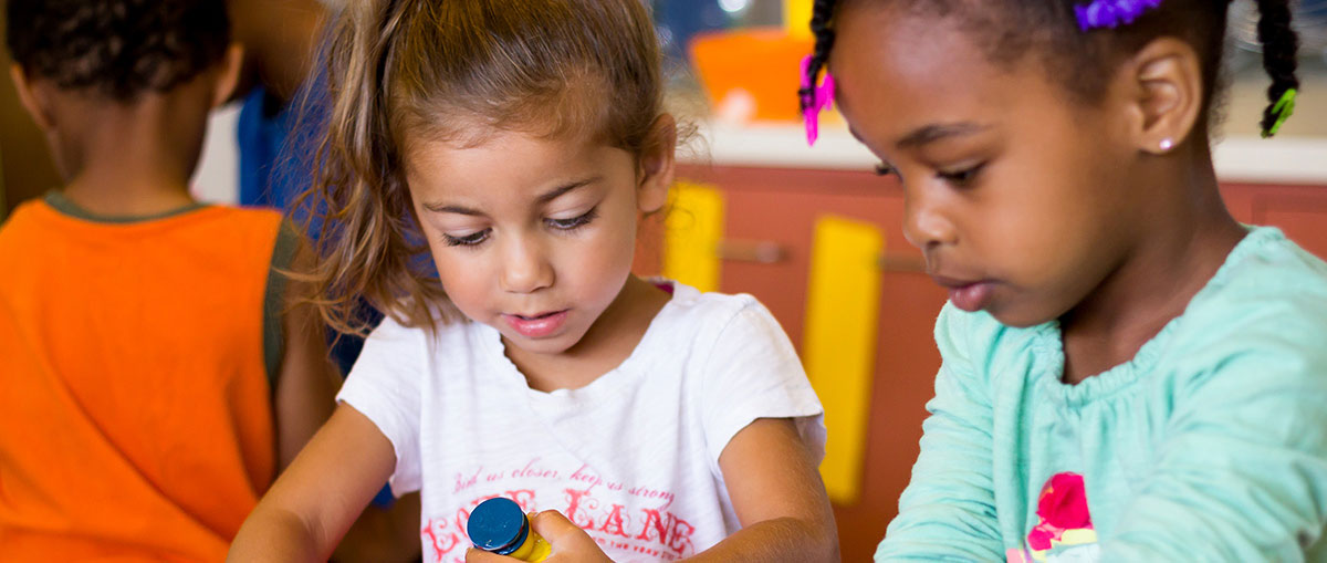 Two girls playing with toys