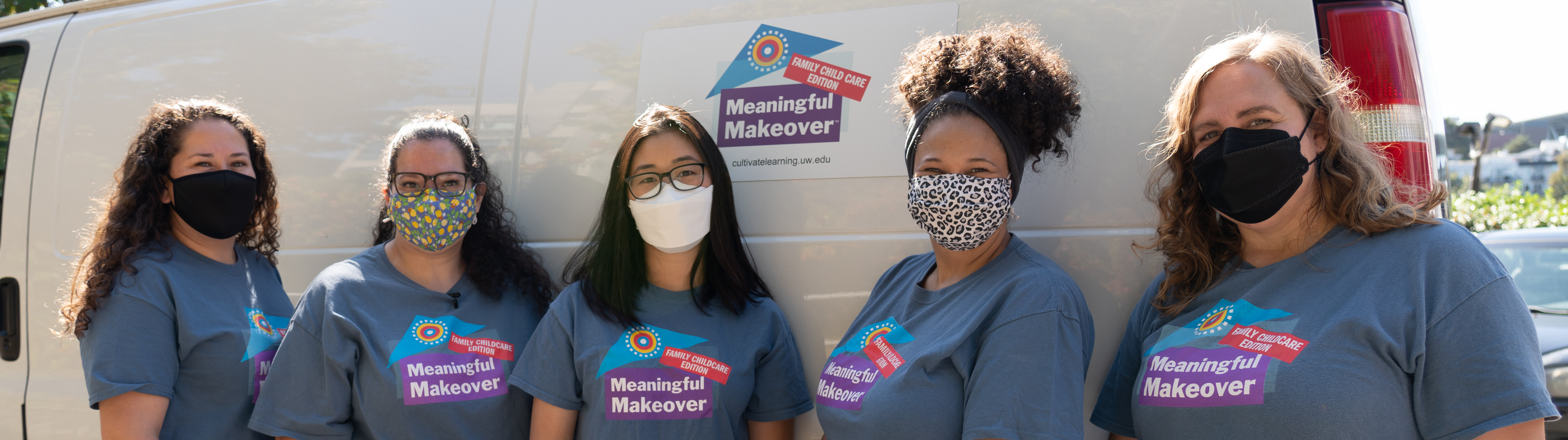 Five members of the Meaningful Makeover team pose in front of white van with Meaningful Makeover logo on it.