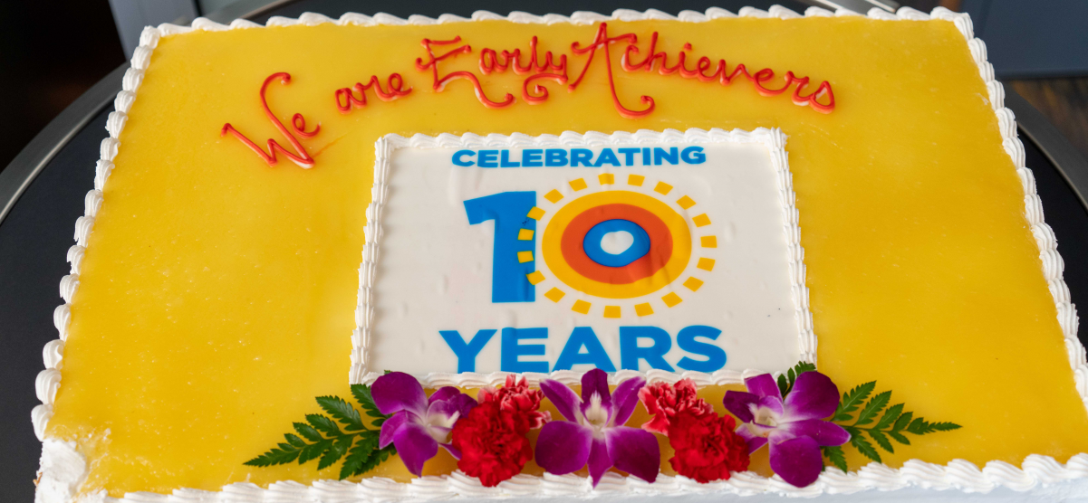 Sheet cake with Early Achievers Celebrating 10 Years logo on it.